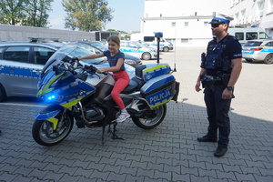 Pamiątkowe zdjęcie dziewczynki na policyjnym motocyklu.