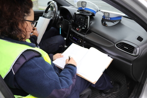 Policjantka podczas dokumentowania czynności służbowych.