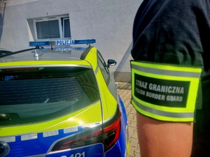 Na zdjęciu naszywka straży granicznej oraz radiowóz.